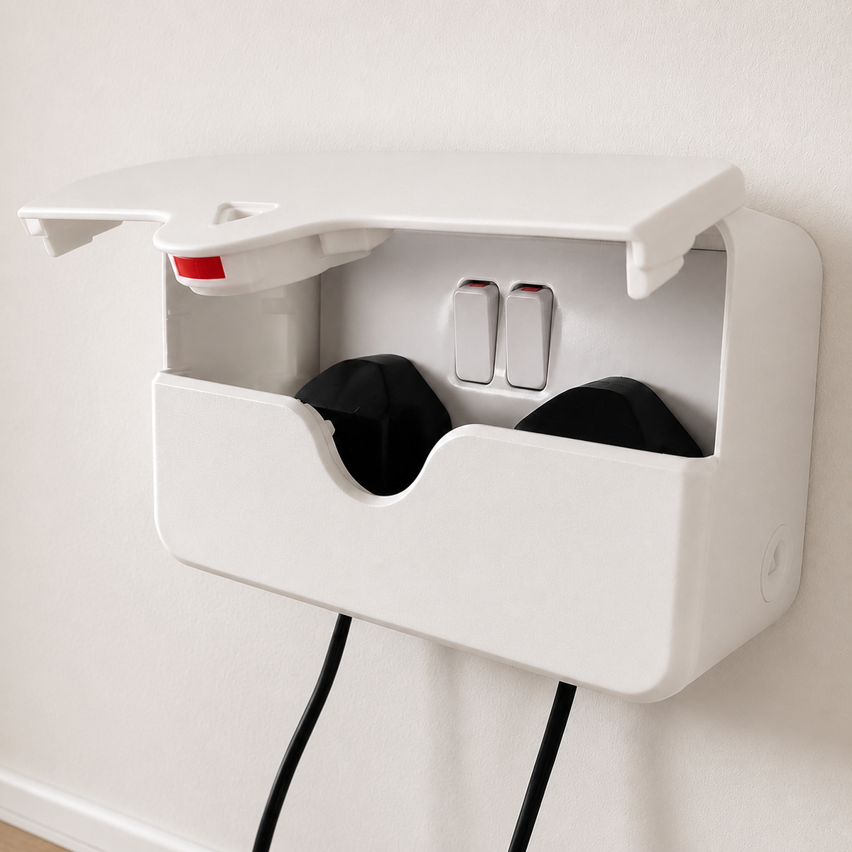 A close-up image of an open double PlugMinder with 2 black plugs in the socket